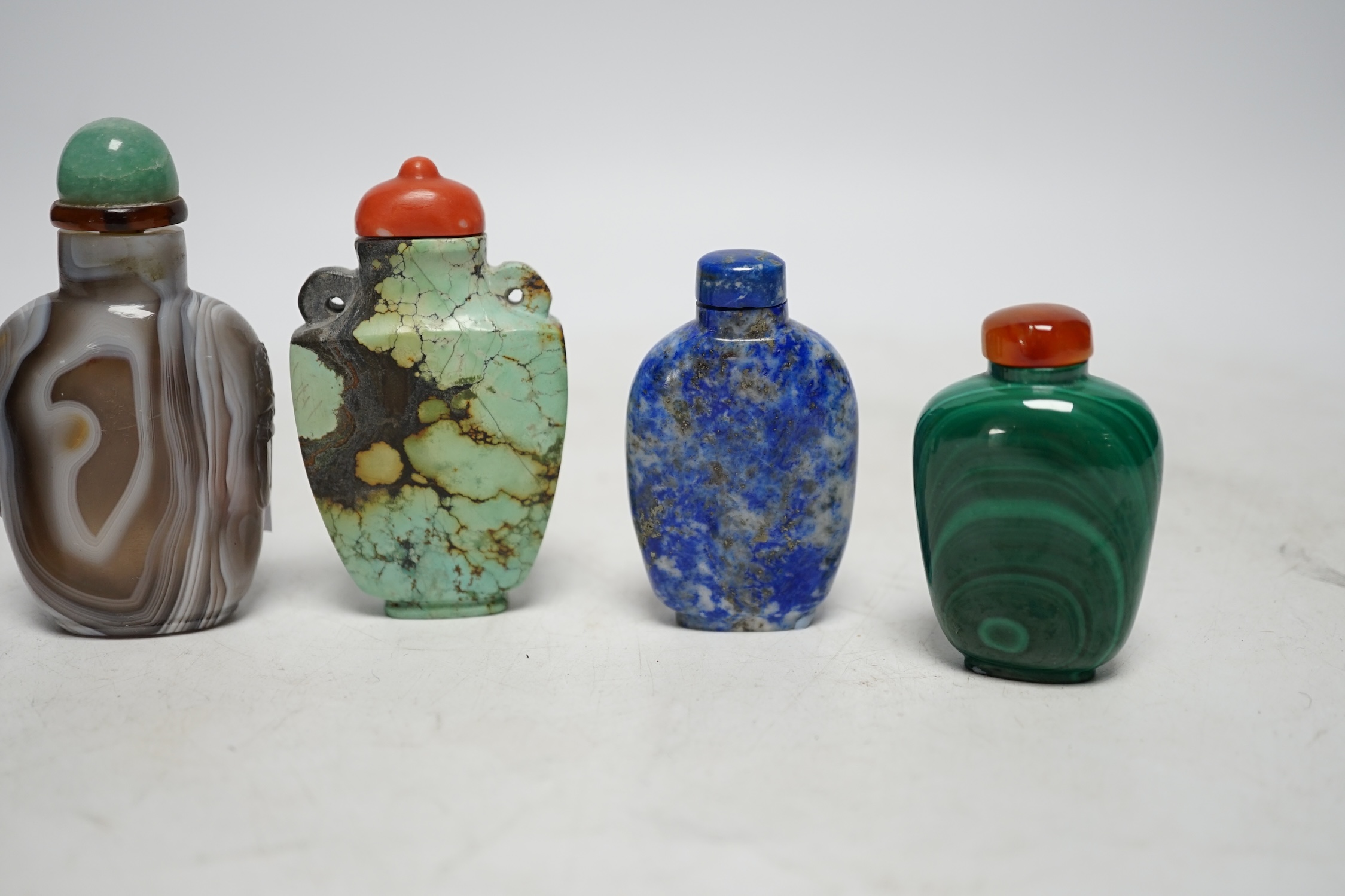 Five Chinese hardstone snuff bottles, 19th/20th century to include: black and grey marble, malachite, turquoise matrix, lapis lazuli and banded agate, largest 7.5cm high